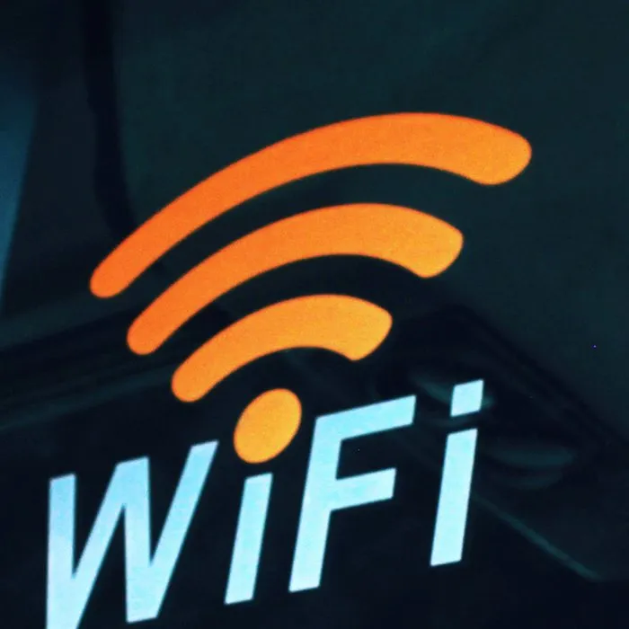 A glowing Wi-Fi sign on a dark wall